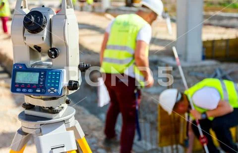 Civil engineer, geodesist is working with total station on a building site Stock Photos
