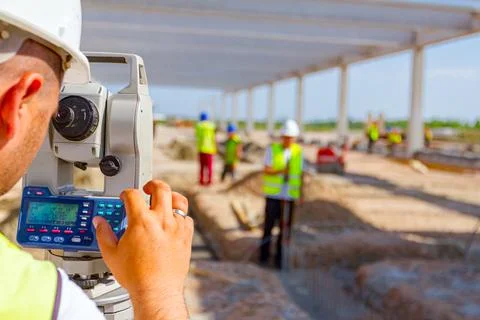 Civil engineer, geodesist is working with total station on a building site Fotos de archivo