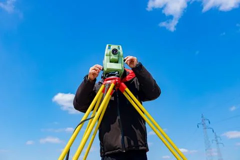 Civil engineer, geodesist is working with total station on a building site Stock Photos