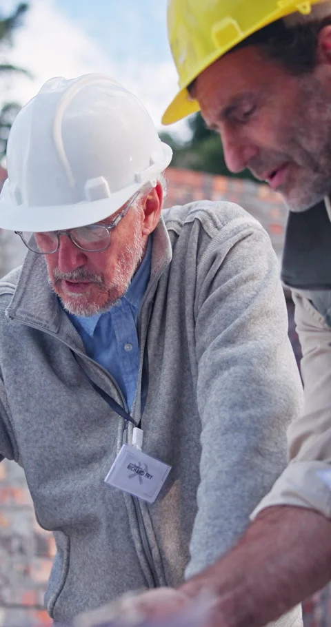 Civil engineer, ideas and men with blueprint on building site, discussion or Stock Footage 340948896