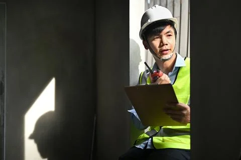 Civil engineer manager standing at construction site and communicating with Foto stock