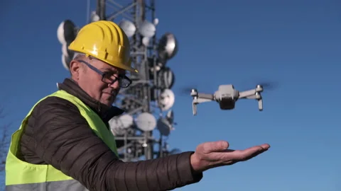 Civil engineer operating a drone with remote control lands the drone at his hand Stock-Footage 170824687
