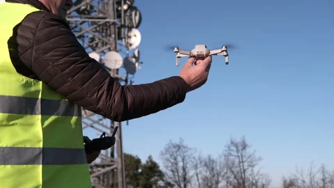 Civil engineer operating a drone with remote control lands the drone at his hand Stock-Footage 170829704