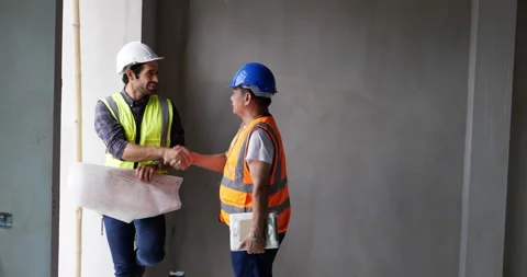 Civil engineer shakes hands then working together Stock Footage 194411962