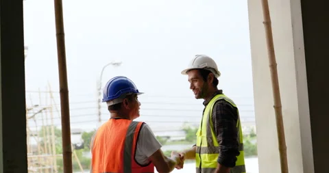 Civil engineer shakes hands then working together at balcony . Stock Footage 194994783