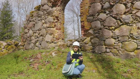 Civil engineer with tablet PC near an old brick wall Stock Footage 335518181