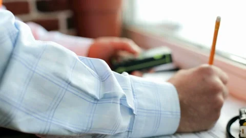 Civil engineer takes notes on drawings Stock Footage 89894699