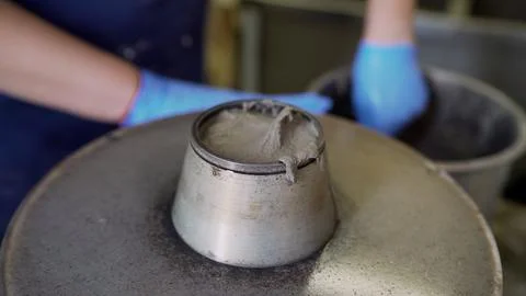 Civil engineer testing consistency of fresh concrete mix using a slump cone.. Stock Photos