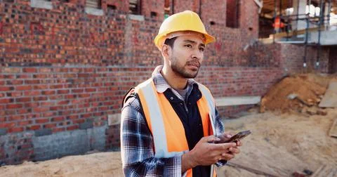 Civil engineer, thinking and man with phone at construction site, typing and Stock Photos