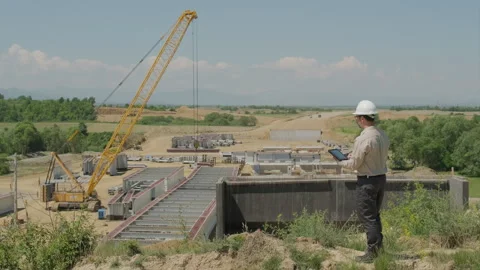 Civil Engineer Using Tablet Updates Data Then Turns And Smiles At Camera Ov.. Stock Footage 337708490