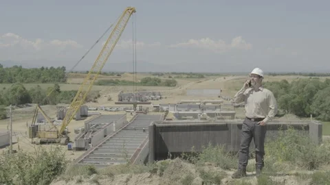 Civil Engineer In White Hard Hat Talking On Mobile Phone At Highway Viaduct.. Stock Footage 337707095