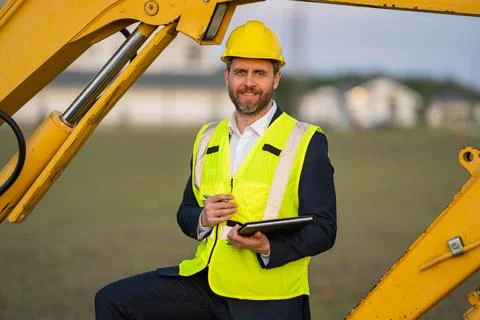 Civil engineer worker at a construction site. Engineer man in front of house Stock Photos