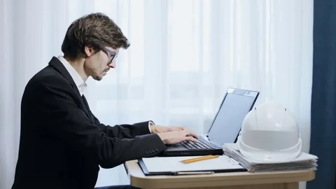 Civil engineer working at a laptop Stock Footage 82531027