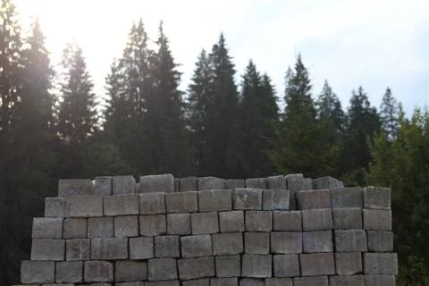 Civil Engineering. Grey Construction Bricks Pile In Front Of Trees Line Stock Photos
