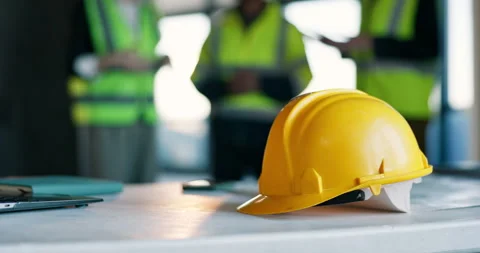 Civil engineering, laptop and helmet on table in meeting, teamwork and ideas for Stock Footage 340777972