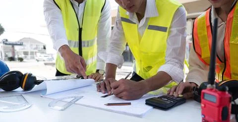Civil engineering team meets to plan work on construction project in the Stock Photos