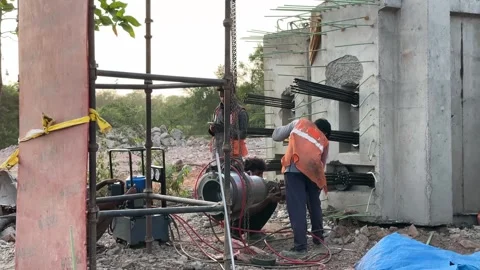 Civil Engineering Workers Performing Post Tensioning on Building Site 4K Stock Footage 336942731