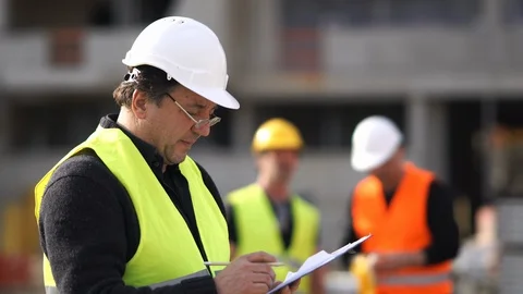 Civil engineers checking plans on construction site Stock Footage 88588347