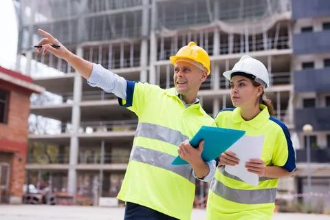 Civil engineers checking work process in construction site Stock Photos