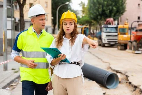 Civil engineers checking work process in construction site Stock Photos