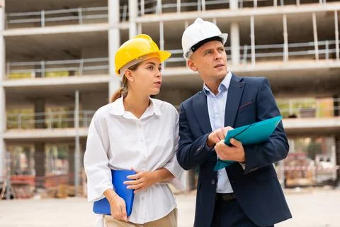 Civil engineers checking work process in construction site Stock Photos