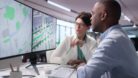 Civil Engineers Discuss Traffic Flow Data While Using Laptop Stock Footage 343881809