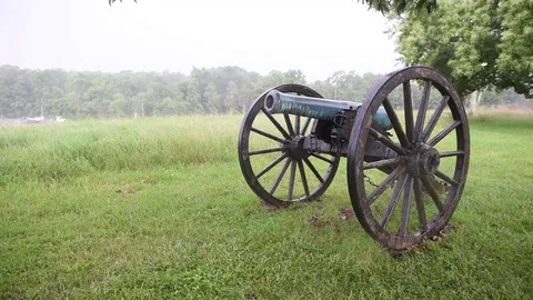 Civil war cannon field rain with traffic in background Stock Footage 76231682