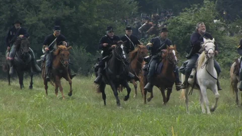 Civil War Union Cavalry Re-enactors gallop across open Battlefield Video stock 111437324