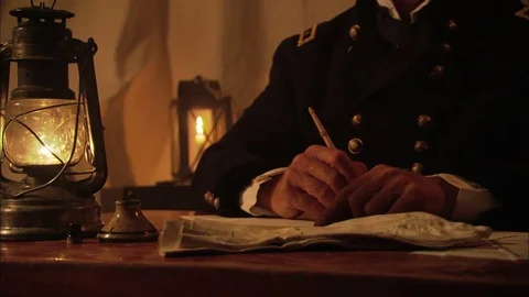 Civil War Union General writes dispatch in tent by oil lamp Stock Footage 81536615