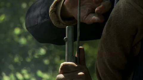Civil War Union soldier muzzle loading his musket with ramrod Stock Footage 148418832