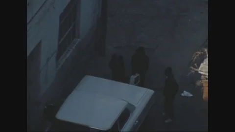 Civilian checking the deck of a white car - 1968 Vídeos de archivo 83659121