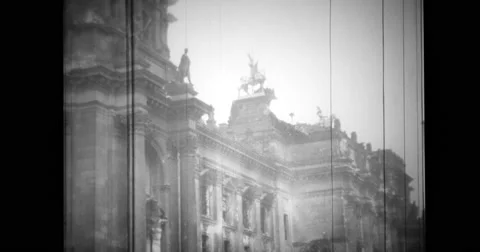 Civilians and soldiers walking past wrecked buildings Stock Footage