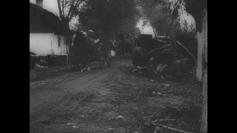 Civilians in carts pass devastation Stock Footage 103389065