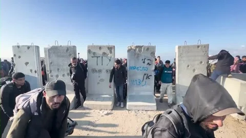 Civilians Passing Between the Blocks Placed by the Israeli Army on Al-Rashid Stock Footage 328039593