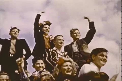 Civilians wave flags in front of Buckingham Palace during celebration - 1945 Stock Footage 103699668