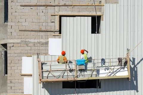 Cladding the building facade. Stock Photos