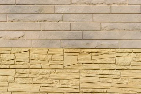 Cladding wall made of natural stone panels in pastel colors. Coverage for ext Stock Photos