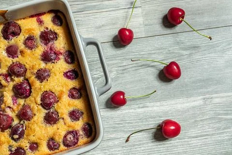 Clafoutis cherry pie in a baking dish Stock Photos