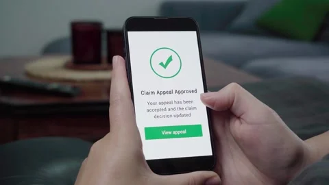 Claim Appeal Approved Notification on Smartphone in Living Room Stock Footage 342670062