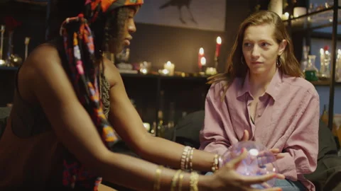 Clairvoyant Examining Crystal Ball with Client Stock Footage 247631466