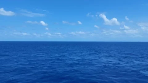 Clam blue sea with small wave under beautiful clear blue sky and empty horizon Stock Footage 154560912