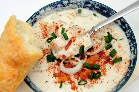 Clam chowder and a bread roll Stock Photos