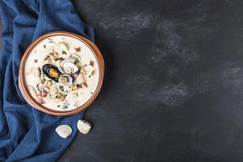 Clam chowder in a brown plate. The main ingredients are shellfish, broth, b.. Stock Photos