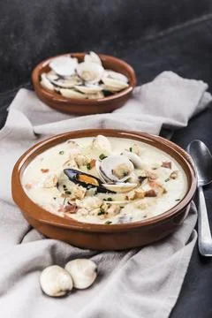 Clam chowder in a brown plate. The main ingredients are shellfish, broth, b.. Stock Photos