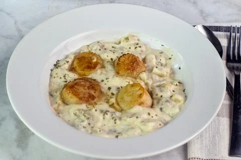 Clam chowder top  scallops and parsley Stock Photos