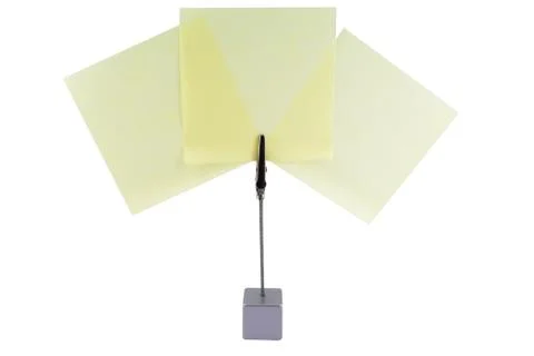 Clamp holding three post-it's. Stock Photos