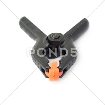 Clamp with orange plastic jaws, isolated over the white background Stock Photos