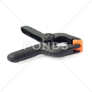 Clamp with orange plastic jaws, isolated over the white background Stock Photos