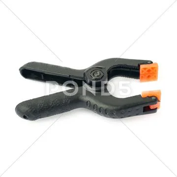 Clamp with orange plastic jaws, isolated over the white background Stock Photos