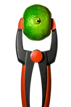 Clamp is squeezing a lime, isolated on white Foto stock